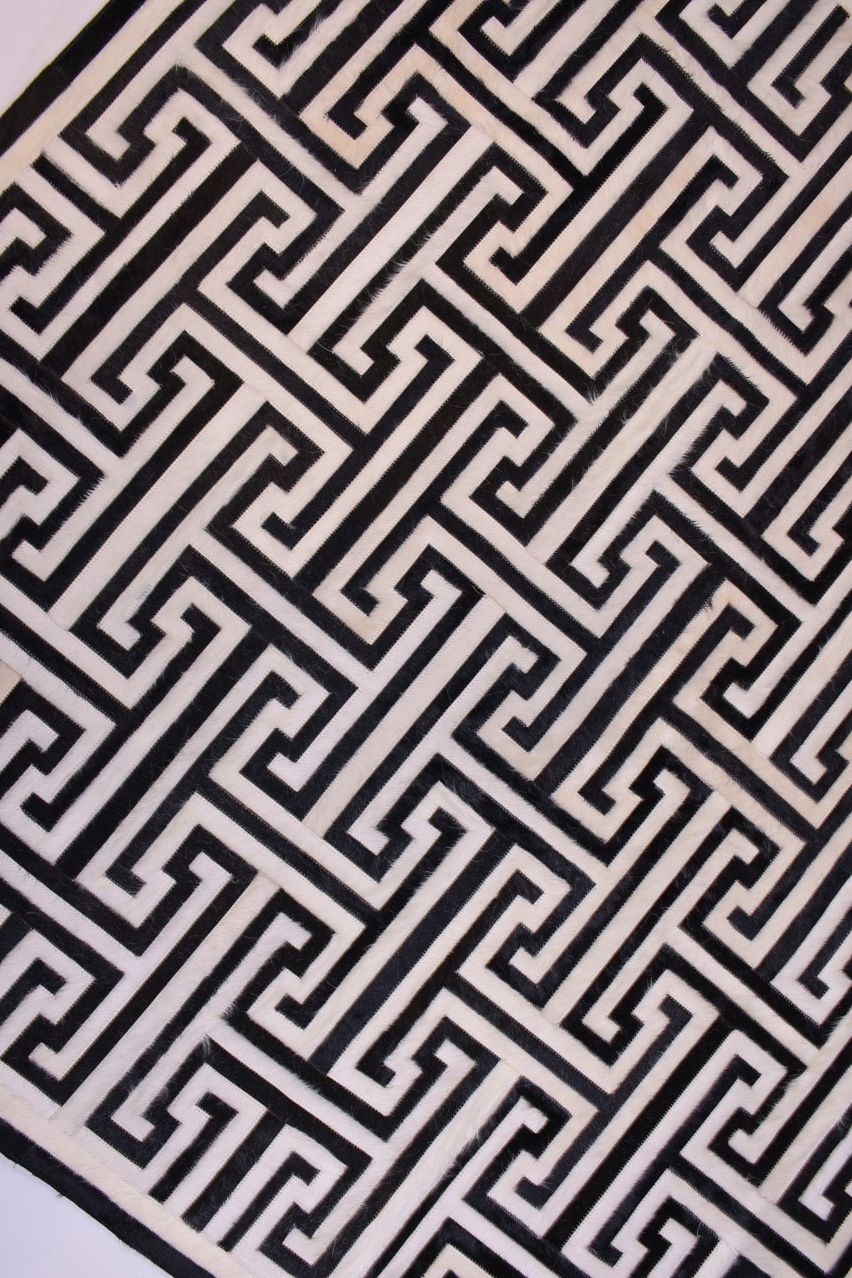 T Model – Maze-Inspired Cowhide Patch Rug